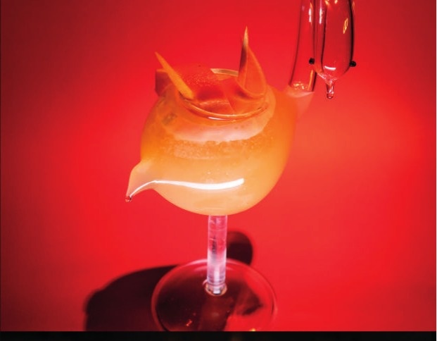 IMA signature cocktail against red backdrop - IMA Val d'Isère Cocktail Bar